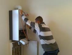 a Rendon plumbing tech inspects a tankless heater